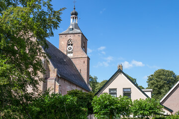 Fototapeta na wymiar Church tower in the picturesque Dutch village of Ruinen in Drenthe.
