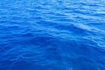 Very nice sea water background or backdrop with selective focus. Small waves of natural water surface texture.