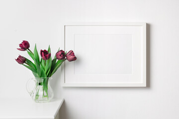 Landscape picture frame mockup on white wall in scandinavian style room interior