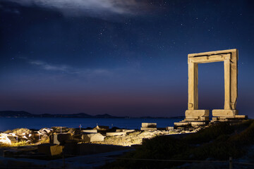 The famous Portara marble gate of Naxos island, Cyclades, Greece, during summer night with starry sky