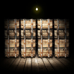 Stacks of wooden crates illuminated by an incandescent lamp