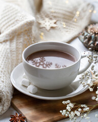 Cup with cocoa and snowflakes
