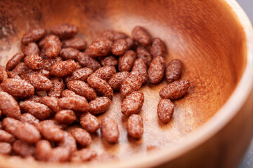 Chocolate cereal puffed rice grains in wooden bowl
