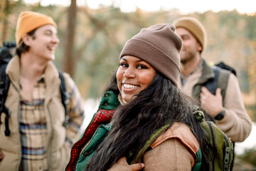 Side view portrait of smiling young woman with friends during staycation