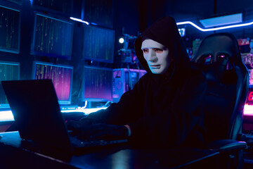 Female Asian hacker in hideout place with dark environment and multiple displays and cables, trying...