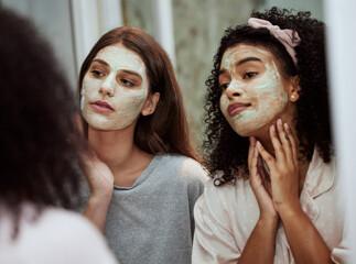 Women, home skincare or face mask bonding in house, bathroom or hotel for spa wellness, girls hospitality or healthcare grooming. Friends, people or beauty facial product for luxury wellness cleaning