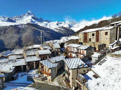Winter view from above of Ostana, an Occitan village below Monviso. It is located in the Po Valley and is included in the list of the most beautiful villages in Italy. 