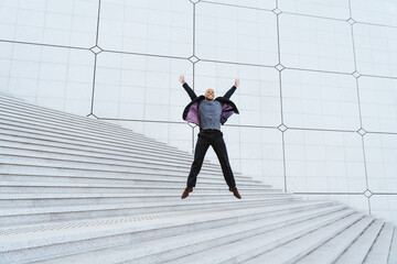 young business man going to work in the morning passing by the financial street area of the city .Representation of a successful sales person reaching the top of the career.