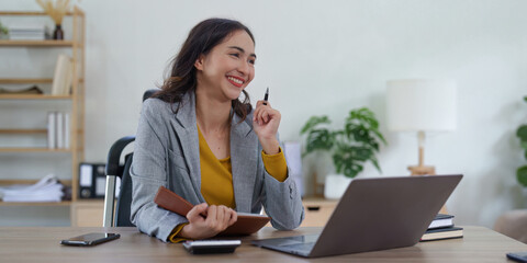 Asian Business woman working at home office and analyze financial report document. Accounting and Finance concept
