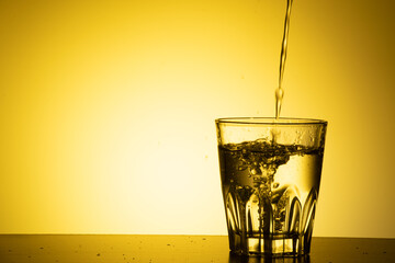 water pour into glass on the table
