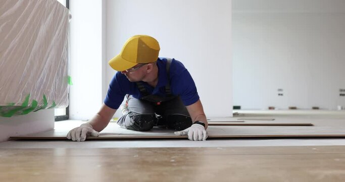Master builder lays parquet floor laminate closeup