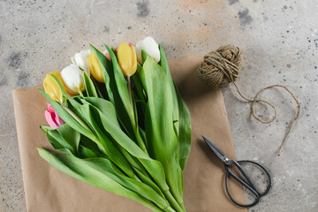 Tulips on craft paper on background. Spring holidays concept