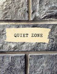 Grunge stone texture brick wall background with text written QUIET ZONE , concept of area used for quiet study, mobile phones banned , loud noise not allowed, privacy needed