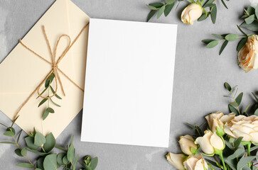 Wedding invntation card mockup with fresh flowers, paper greeting card with copy space