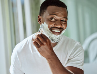 Cream, razor and shaving black man in the bathroom for skincare, beard grooming routine and facial...