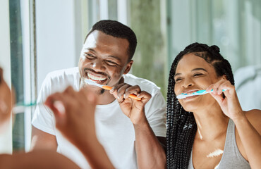 Brushing teeth, dental and oral hygiene with a black couple grooming together in the bathroom of their home. Health, tooth care and cleaning with a man and woman bonding during their morning routine - Powered by Adobe
