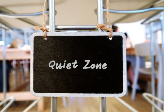 Black Small Chalkboard Hanging In Coworking Space With Text Handwritten Quiet Zone, Concept Of An Area In Coworking Space Or Library Or Office Which Need Silence , Or An Introvert Need Privacy