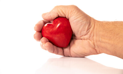hand holding red heart from stone