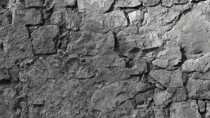 gray background, in the photo an old gray stone wall close-up