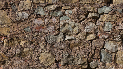 stone wall, in the photo an old brown stone wall close-up