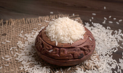 Uncooked dry rice in wooden bowl, Healthy food. Copy space.