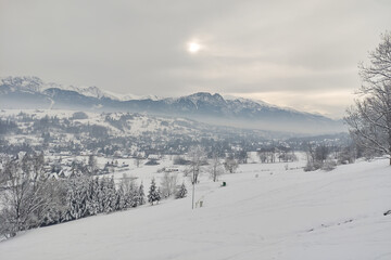 Fototapeta na wymiar mountain landscape in winter. against the background of mountains, a European village in the snow
