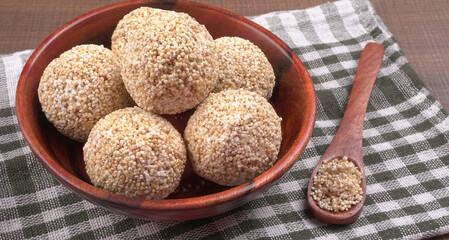 Amarnath seed, Cholai or Rajgira laddo, Also in cube shape called chikki or cake form, Indian sweet and healthy food served in a plate and bowl. Selective focus.