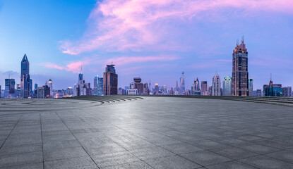 Empty square floor and city skyline with modern buildings at sunset in Shanghai, China.