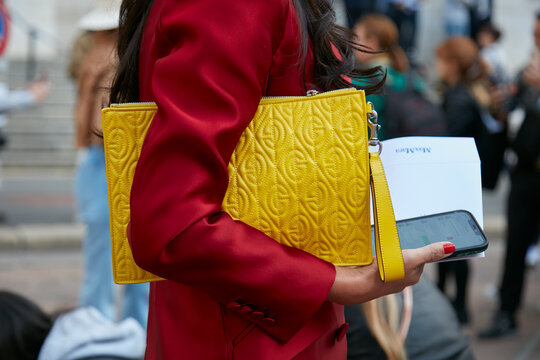 Woman with yellow Gucci bag and red jacket on September 22, 2022 in Milan, Italy