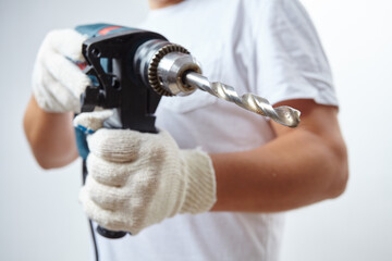 man holding a cordless screwdriver in his hand.