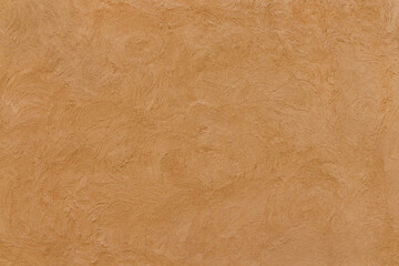 Old traditional house wall texture in Shindaga, Dubai. Brown sandy color rough plaster background.