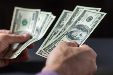 Close up male hand Counting money us dollar. Financial business concept.