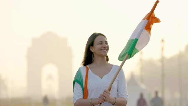 Indian girl looking towards Indian flag