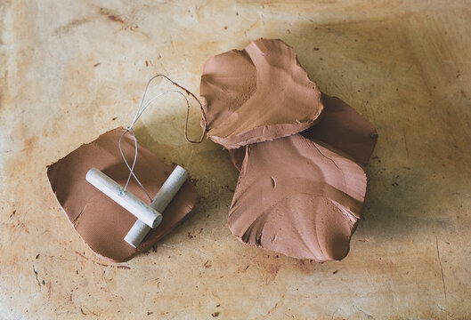 Overhead view of clay and pottery equipment on table in workshop