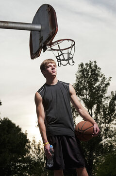 Young man poses for a portrait after playing basketball at Barstow Park in Vermillion, South Dakota.