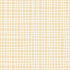 White on beige graph paper. Hand drawn seamless pattern. Uneven vertical and horizontal criss cross lines. For textile, wrapping paper, wallpaper, stationery and packaging design
