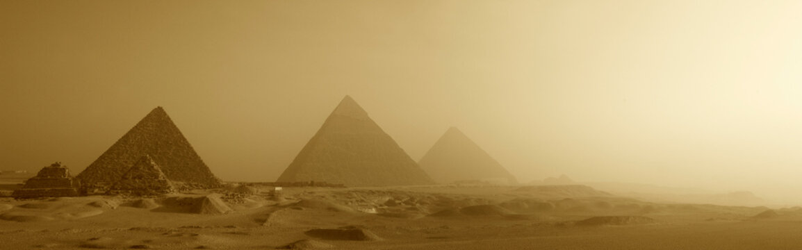 A panoramic view of The Great Pyramids at sunrise