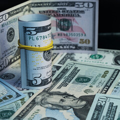 Fototapeta premium Banknotes of 5 US dollars, Stacks of money from a banknote of 5 dollars, top view. five dollar bill Abraham Lincoln