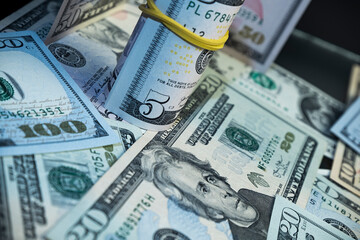 Fototapeta premium Banknotes of 5 US dollars, Stacks of money from a banknote of 5 dollars, top view. five dollar bill Abraham Lincoln