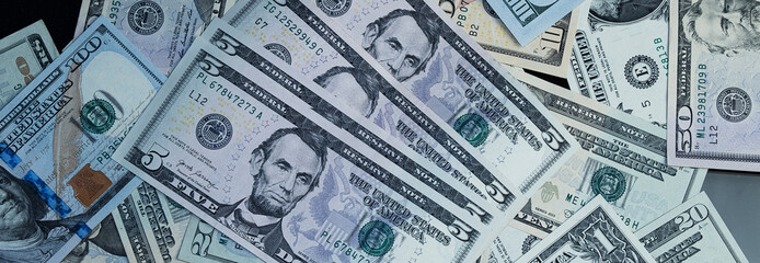 Banknotes of 5 US dollars, Stacks of money from a banknote of 5 dollars, top view.
five dollar bill Abraham Lincoln