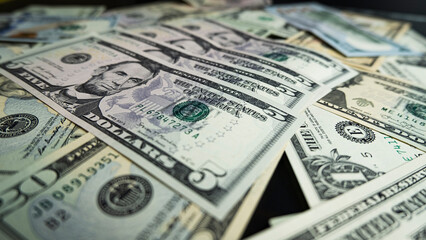 Banknotes of 5 US dollars, Stacks of money from a banknote of 5 dollars, top view.
five dollar bill...