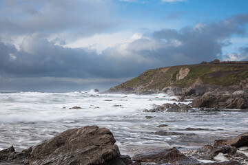 Waves rolling onto a Cornish rocky Beach on a windy day