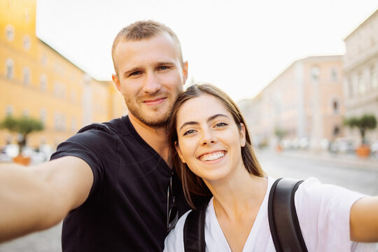 Happy Young couple taking selfie portrait with smartphone mobile outdoor. Tourism, friendship, youth and weekend activities concept. Close up portrait. Tourism, selfie photos, bloggers