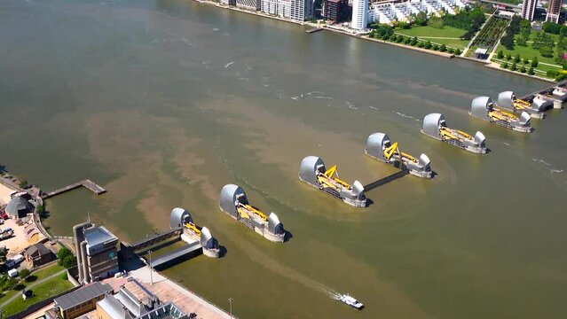Aerial view of the Thames Flood Protection Barrier with one gate closed and Control centre. Woolwich, London, UK.
