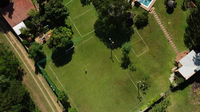 Top View Of Beautiful Rest Cottage House With Blue Pool Near Green Sports Courts 