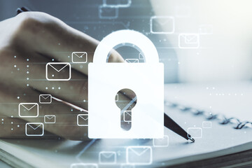 Creative lock sketch with email symbols hologram and man hand writing in notepad on background, protection of personal data concept. Multiexposure