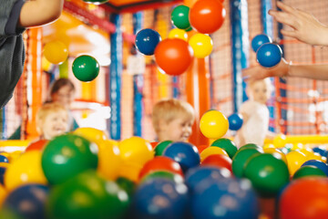 School children having fun in indoor park playground. Happy boy playing at balls pool playground....