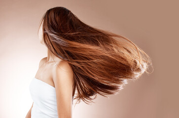 Beauty, hairstyle and hair care of woman in studio on a brown background. Haircare, cosmetics and...