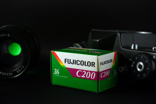 Ryazan, Russia - February 27, 2021:  Close up of packaging Fujifilm Fujicolor C200 color negative film with camera and lens