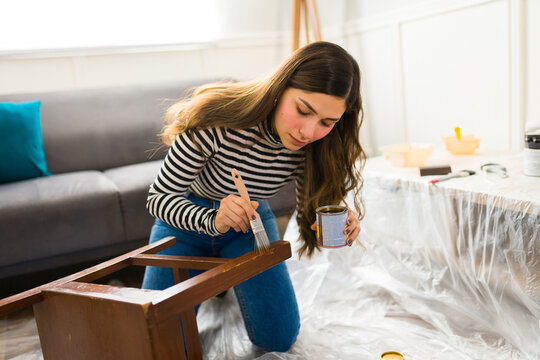Attractive woman making furniture flipping